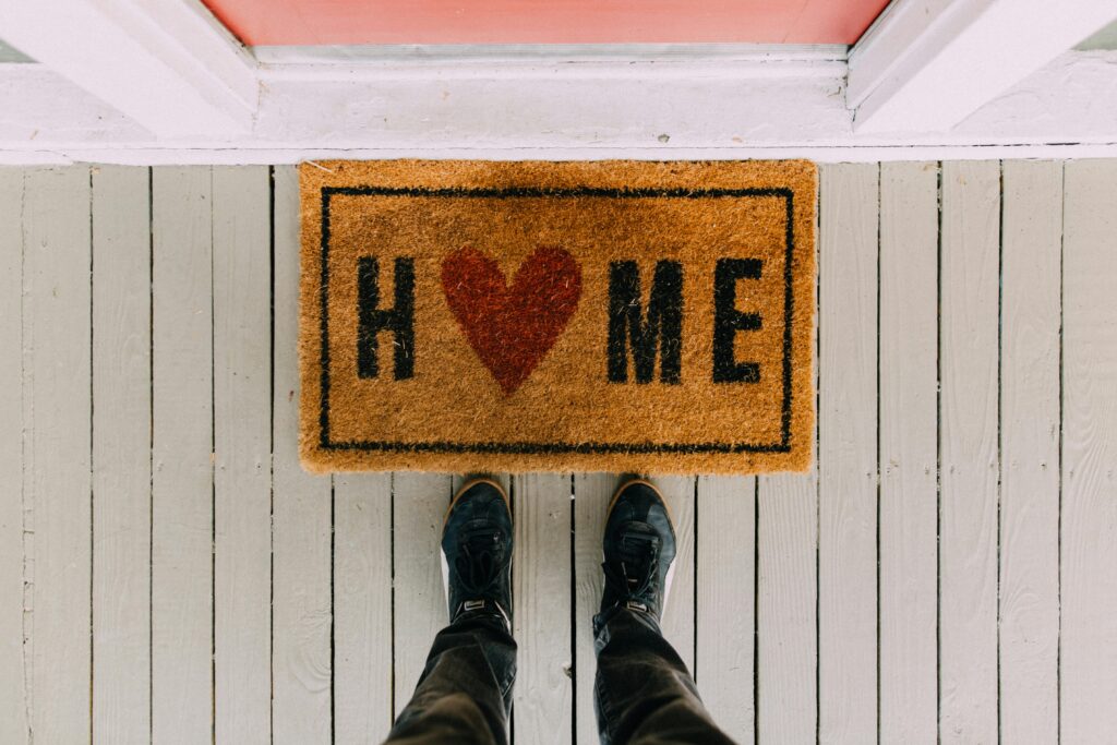 pexels-photo-2950003-2950003 A creative doormat with heart motif symbolizing home at a front porch entrance.